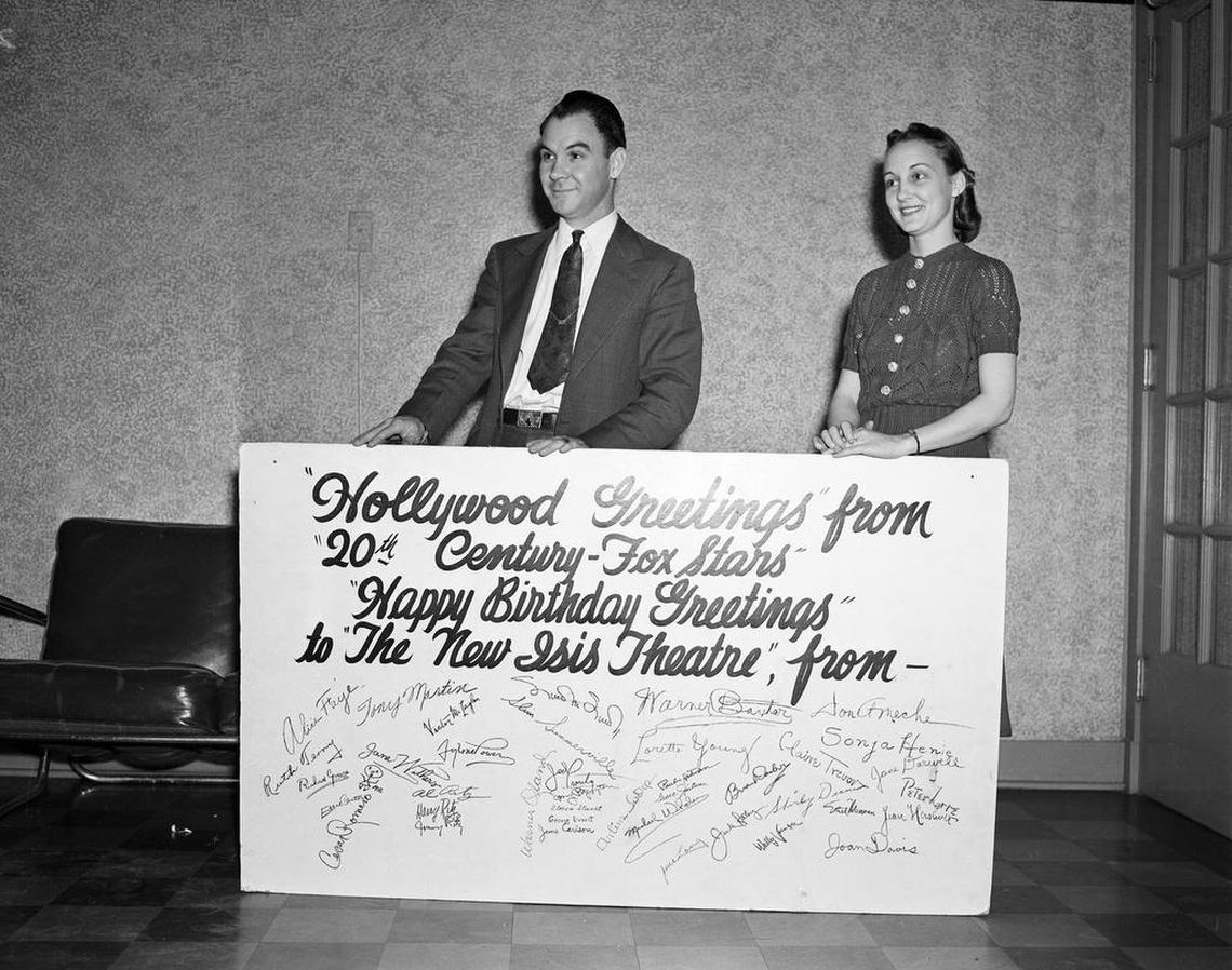 On the New Isis’ second anniversary in 1938, Twentieth Century Fox Inc. sent the New Isis a huge greeting card displayed by L.A. Wallis, assistant manager, and Reba Long.