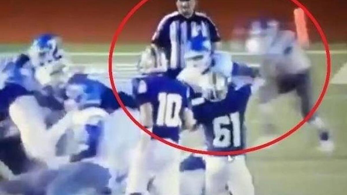 
A San Antonio John Jay High School football player, top right, appears to intentionally hit umpire Robert Watts during a game Friday at Marble Falls.
