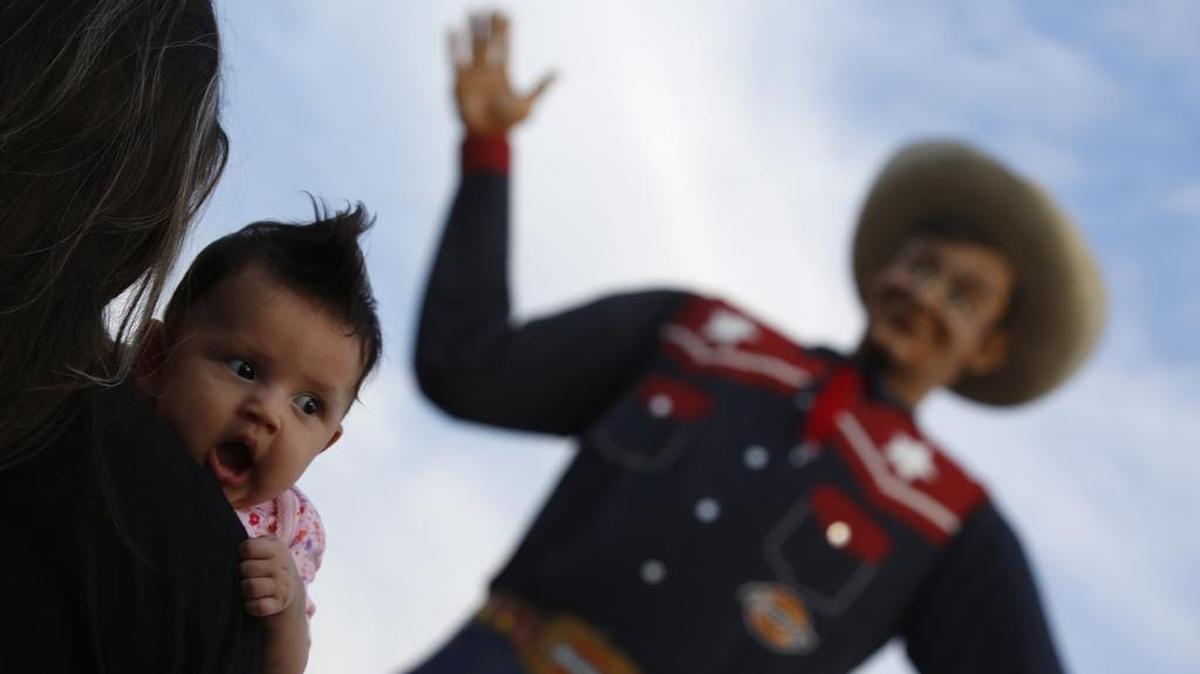 Violet Vargaz, 3 months, yawns in front of Big Tex at the 2014 State Fair of Texas in Dallas.