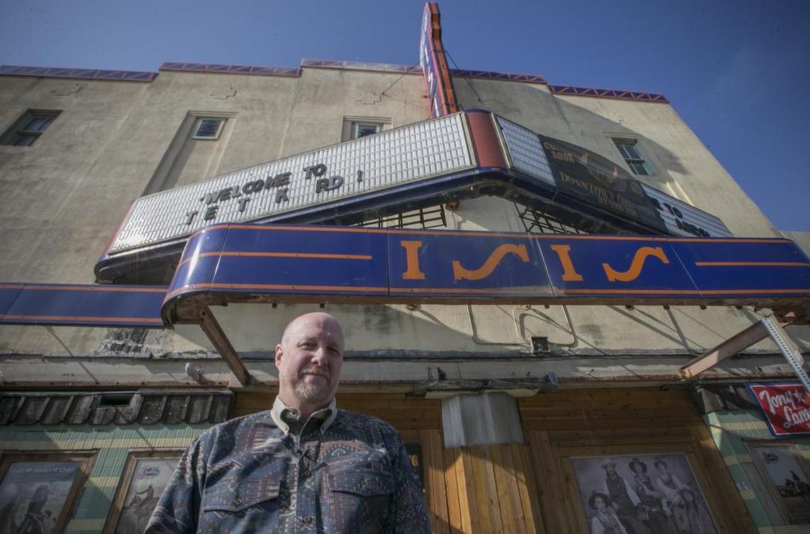 Jeffrey S. Smith stands beneath the New Isis Theater marquee. The theater was built in 1935 and opened the following year.