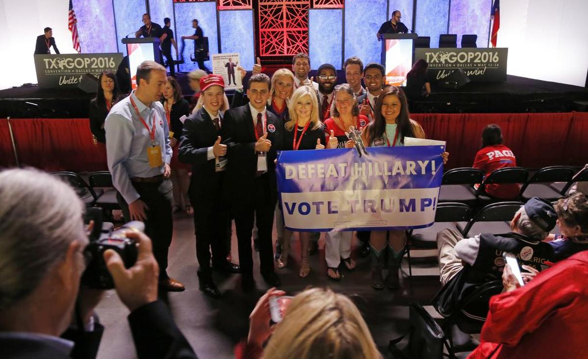 A small group of Donald Trump supporters gathers after U.S. Sen. Jeff Sessions’ speech urging unity behind Trump.
