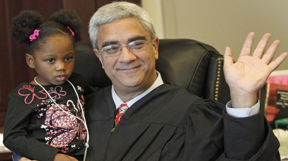 In 2011, Judge Mike Sinha held newly adopted Azan’I Jefferson, 3, on National Adoption Day.