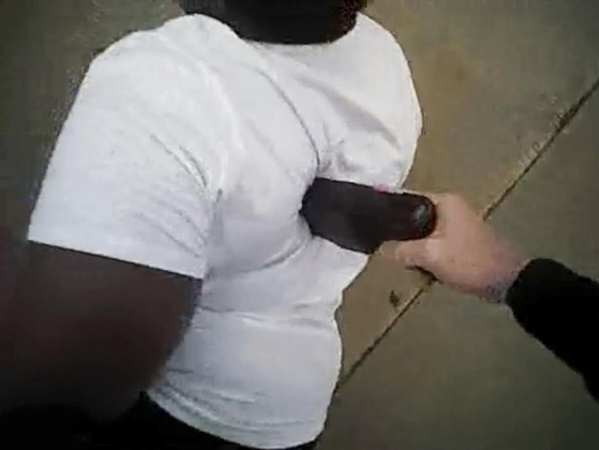 Fort Worth police officer William Martin pushes Jacqueline Craig down with a Taser.