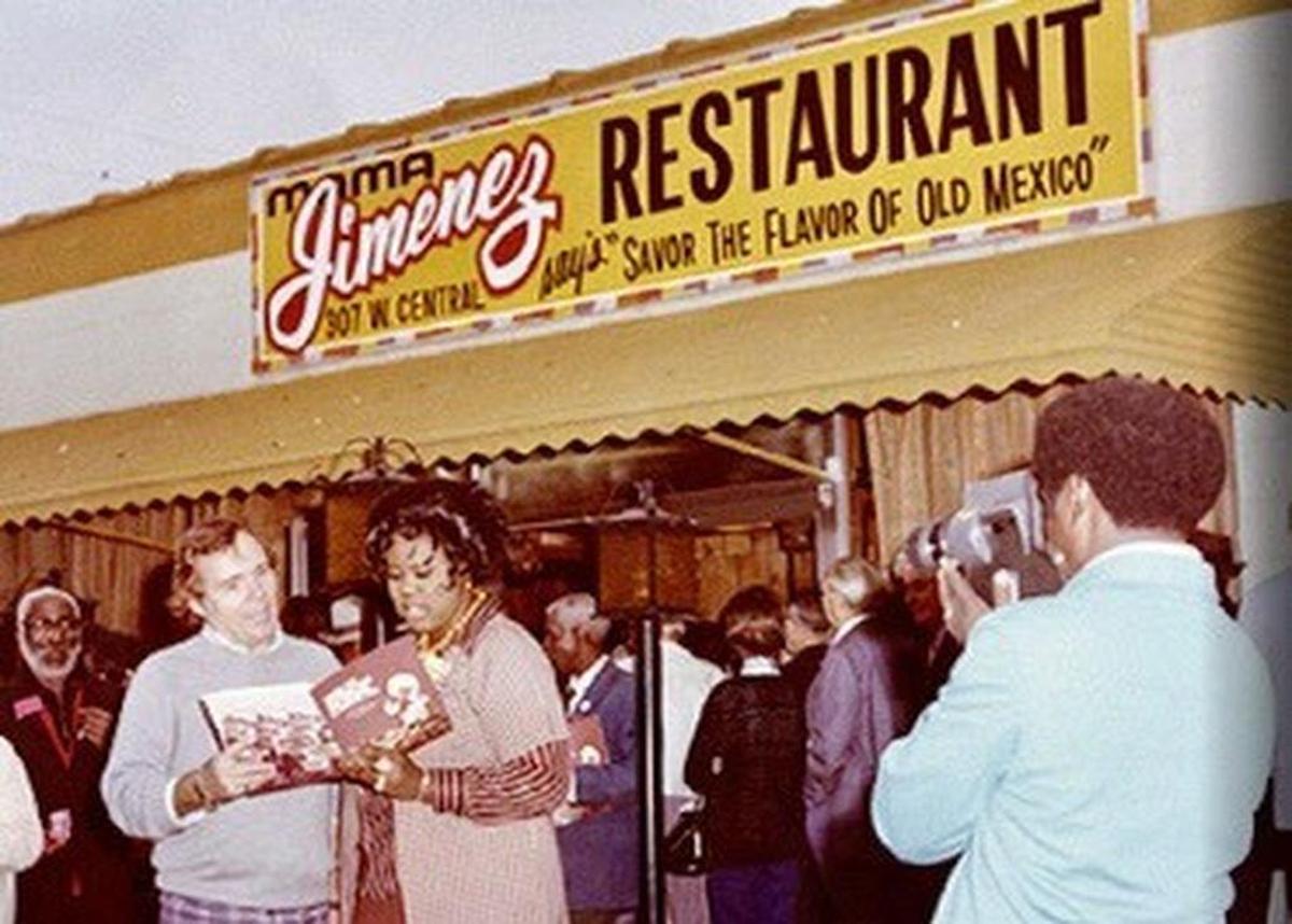 Reporter Jerry Thomas of KTVT/Channel 11 films Christmas carolers at the old Jimenez Restaurant in Fort Worth.
