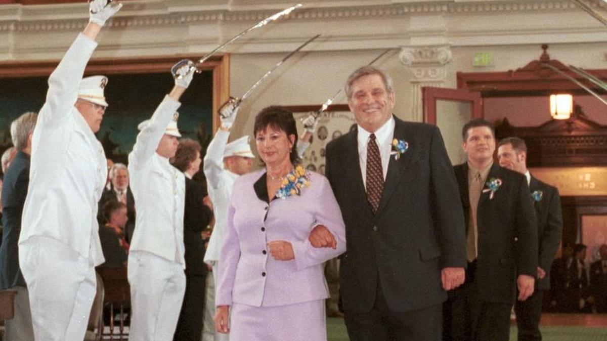 Tammy and Sen. Chris Harris pass through the honor guard in 2001, when Harris was sworn in as “Governor for a Day.”