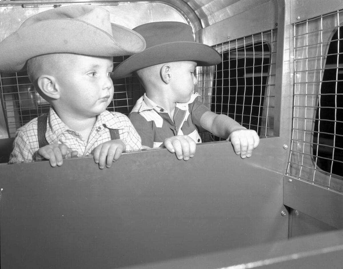 Leonards was a popular 1950s and 1960s Christmas shopping stop for children. Here, Kenny and Stanley Bennett of Arlington ride “Santa’s Rocket Express” monorail in the Toyland shop.