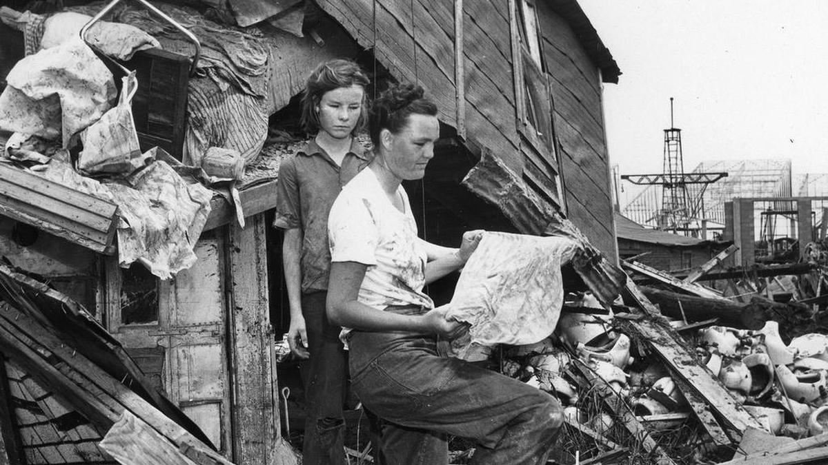 A woman and child — their names are not listed in archives — go through remnants of a destroyed Fort Worth home.