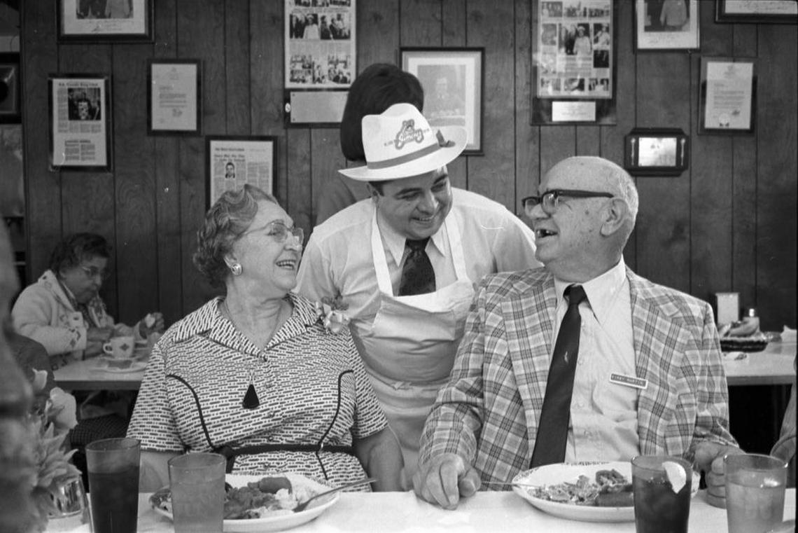 Raul Jimenez serves Thanksgiving dinner to Mr. and Mrs. Kirby Martin at the Jimenez Restaurant in 1974. The Martins are members of the North Side Senior Citizens Club.