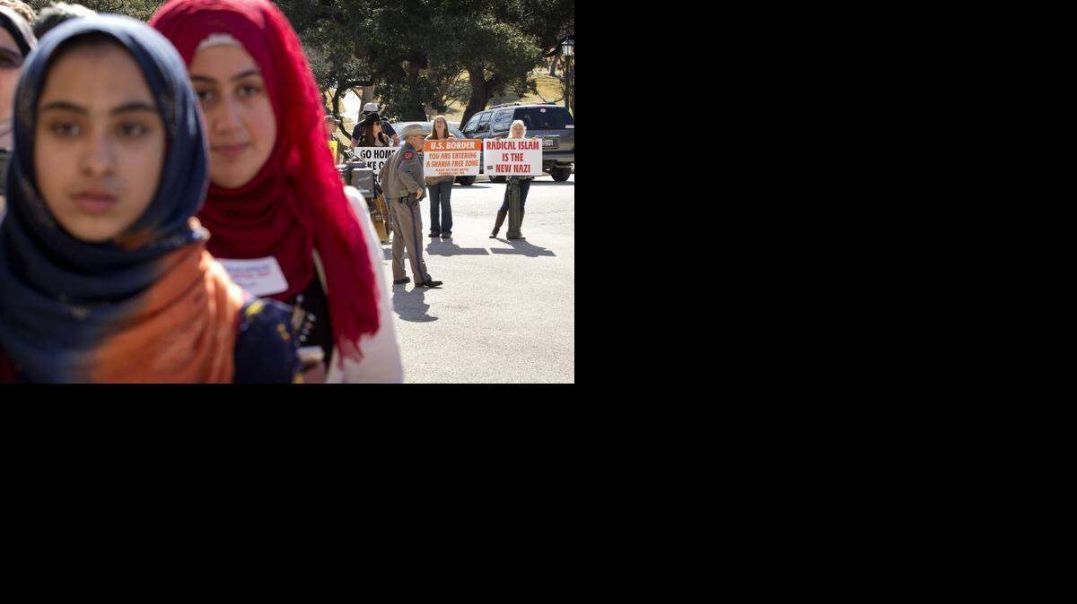 
Fatima Burney, 14, of Fort Worth, and Marwa Qudah, 17, of Katy, are faced with anti-Muslim protesters during the Texas Muslim Capitol Day Jan. 29 in Austin. Hundreds of Muslims from around Texas gathered for the Council on American-Islamic Relations rally and to talk to lawmakers
