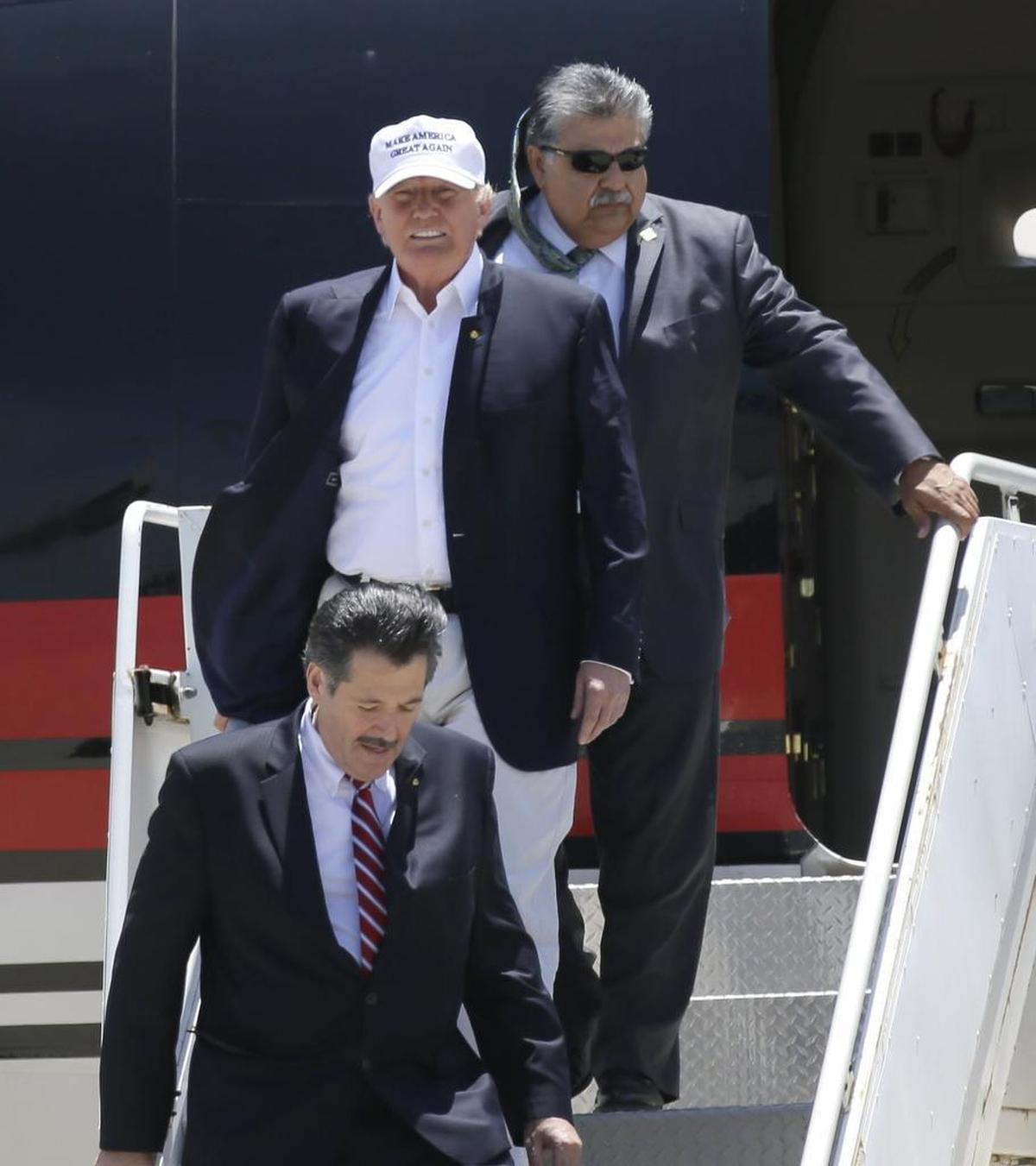 Republican presidential hopeful Donald Trump arrives in Laredo, with city manager Jesus Olivares behind him.