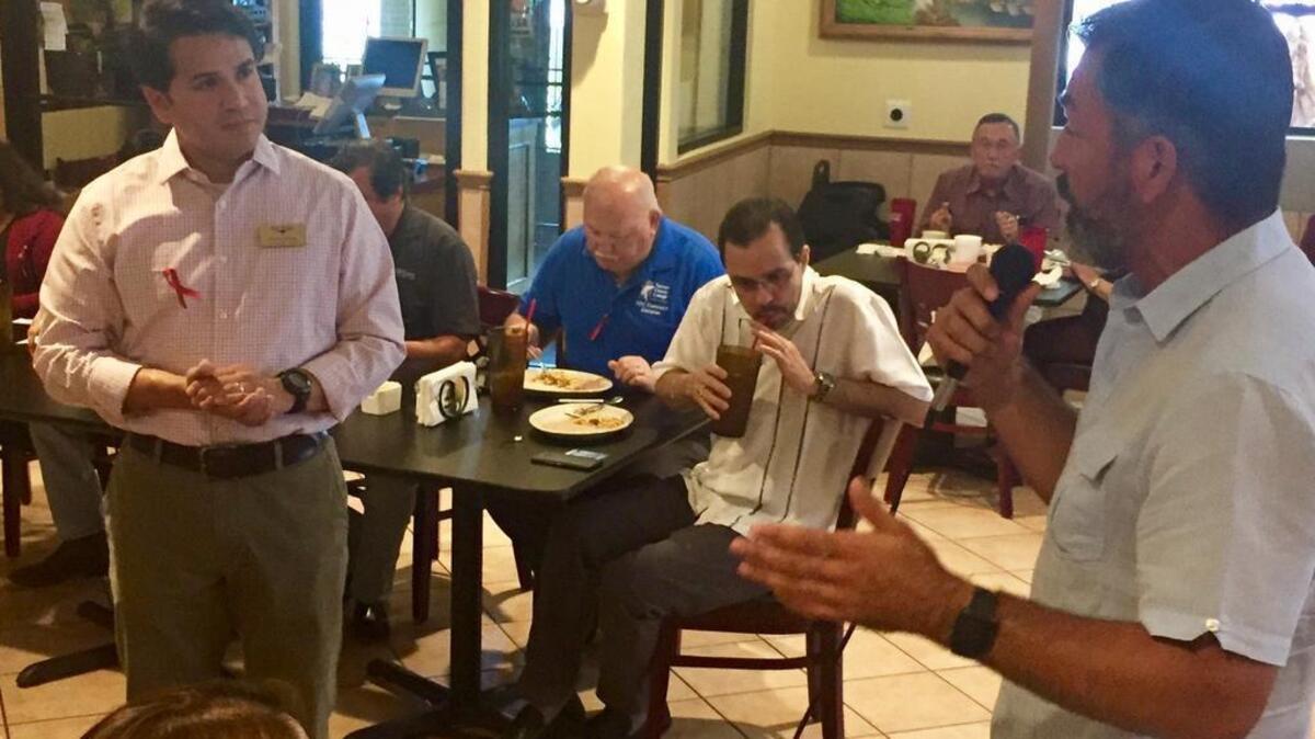 State Rep. Ramón Romero, right, confronts City Councilman Carlos Flores asking when the council will take a position on Senate Bill 4. Both spoke at the monthly public Chorizo & Menudo Breakfast at Nuevo León restaurant.