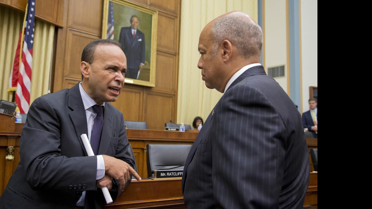 
House Judiciary Committee member Rep. Luis Gutierrez, D-Ill., left, talks to Homeland Security Secretary Jeh Johnson on Tuesday on Capitol Hill in Washington before a committee hearing.

