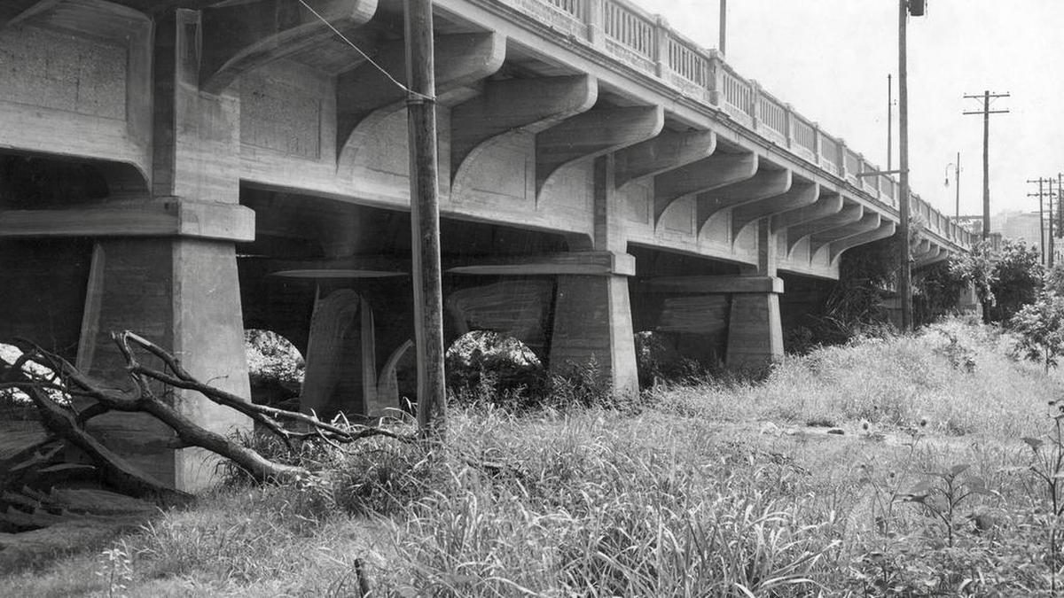 In 1949, trees, grass and brush lined the Clear Fork under the Seventh Street bridge, slowing the flow of water. The banks were replaced with smooth levees.