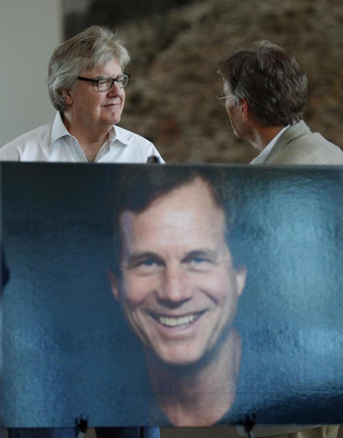Friends Bob Lukeman and Walker Friedman visit behind a portrait of actor Bill Paxton at a tribute at the Modern Art Museum of Fort Worth.