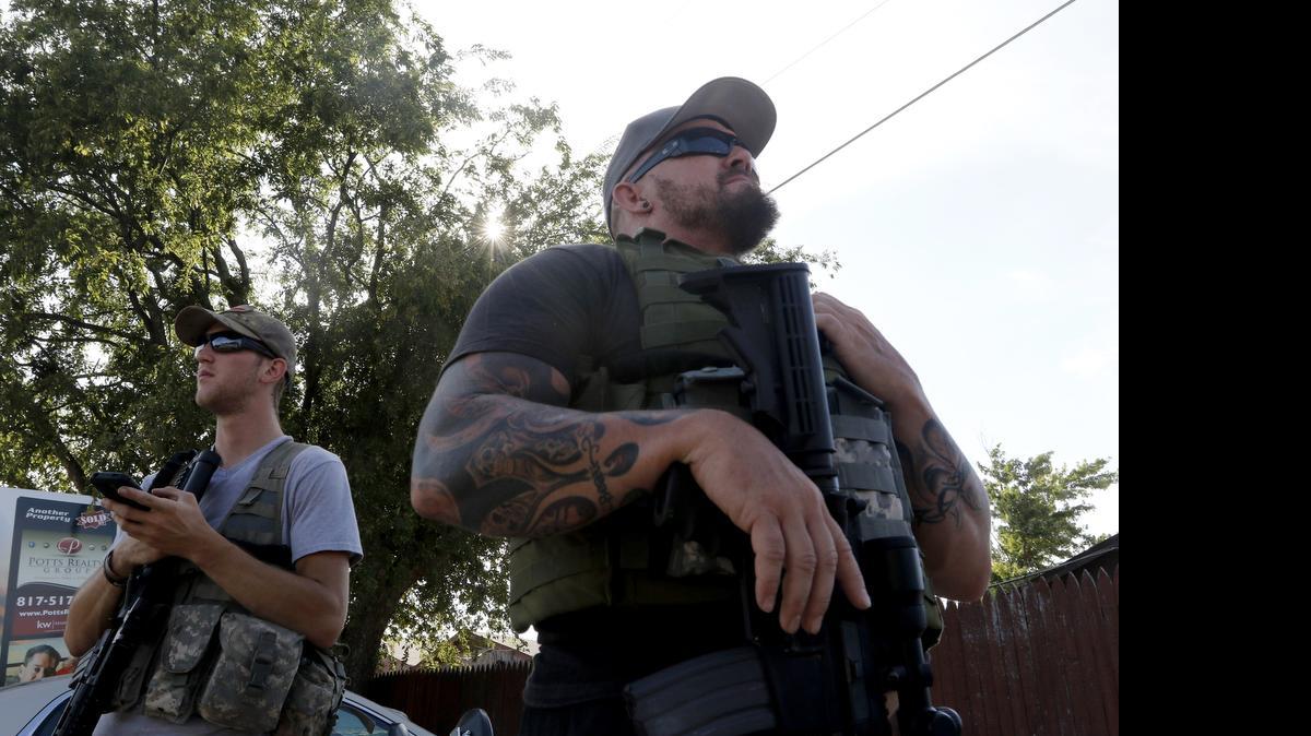 
Jerry Blakeney, right, and Tyler Pinkston of Operation Hero Guard protect a U.S. military recruiting station in Cleburne.
