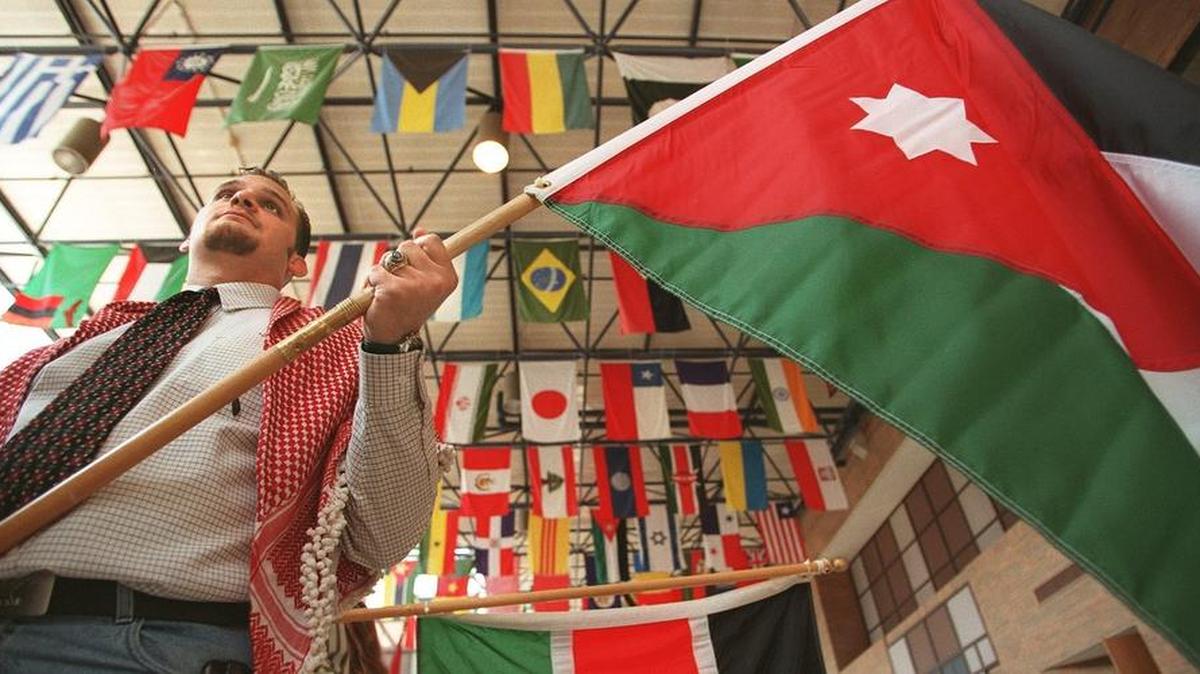 The international enrollment at UT Arlington is reflected by a past International Week exhibit. Then-student Fares Haddad holds a Jordanian flag in a file photo.