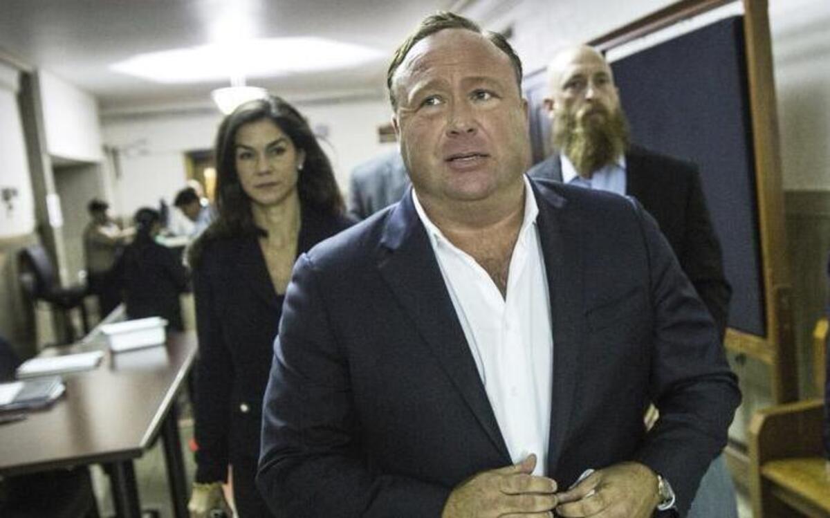 Alex Jones, a conspiracy hobbyist and video host, arrives for a child custody trial in Austin.