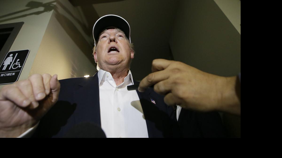 Republican presidential hopeful Donald Trump speaks to reporters after arriving for a visit to the U.S. Mexico border in Laredo