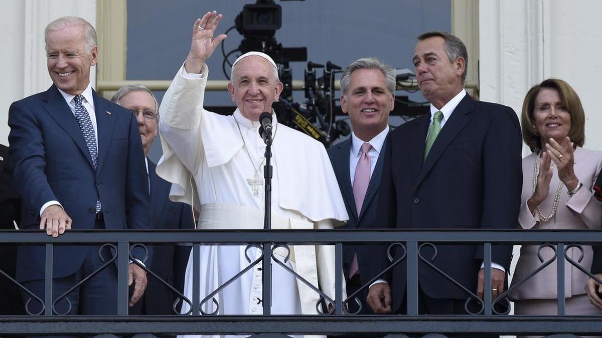 
Pope Francis, center, waves to the crowd Sept. 24 on Capitol Hill as he stands with congressional leaders. 
