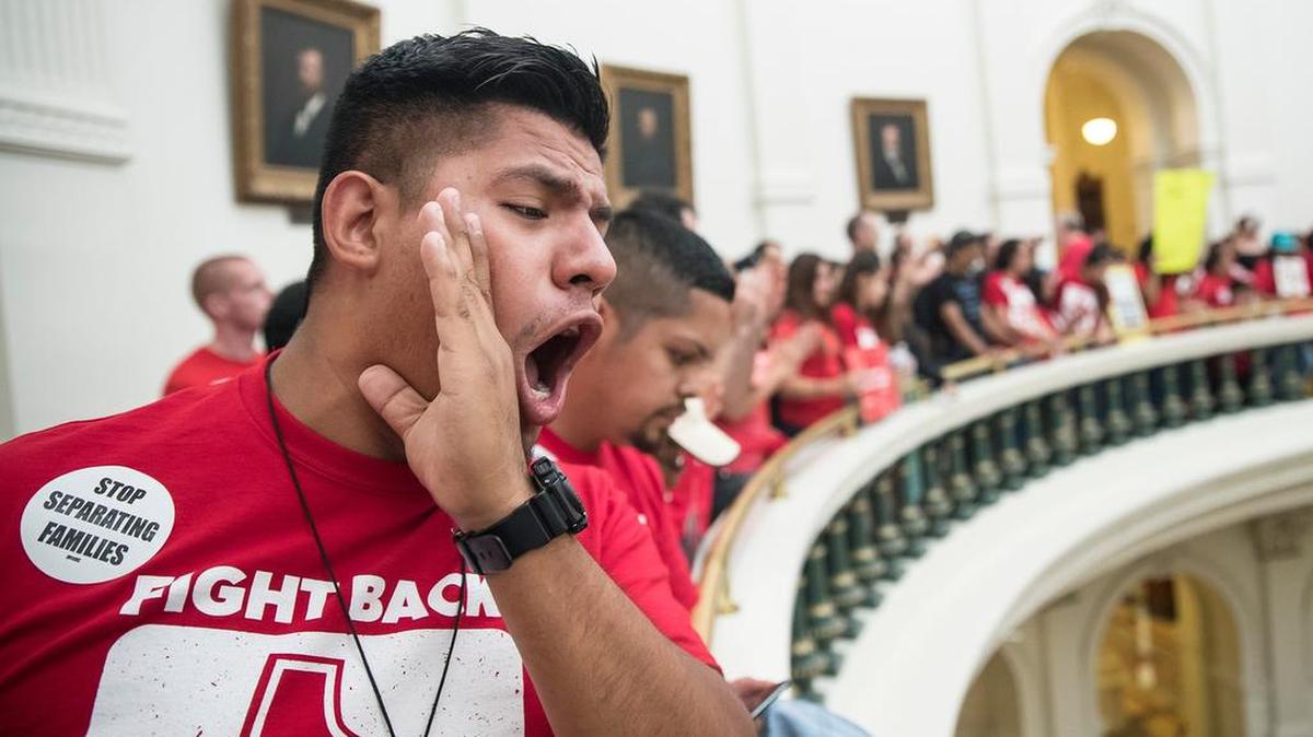 Pedro Paredes joins hundreds of protesters lining the balconies of the state Capitol rotunda in Austin on May 29, the last day of the legislative session, to protest Senate Bill 4, legislation passed by Texas Gov. Greg Abbott that compels local police to enforce federal immigration law.
