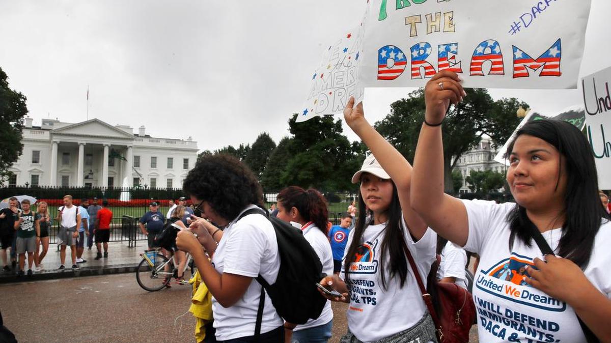 Daisy Leon, 26, right, of Perth Amboy, N.J. and a recipient of DACA, attends a rally at the White House in Washington, Tuesday, Aug. 15, 2017, along with others in favor of DACA and immigration reform. The marchers want to preserve the Obama administration program known as Deferred Action for Childhood Arrivals, or DACA. The Trump administration has said it still has not decided the program's fate.
