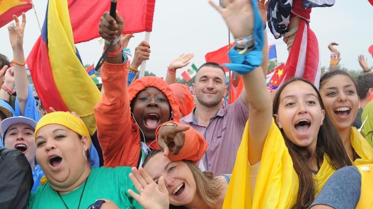 Faithful participating in World Youth Day greet Pope Francis as he rides in his pope-mobile in Krakow, Poland, Thursday, July 28, 2016.