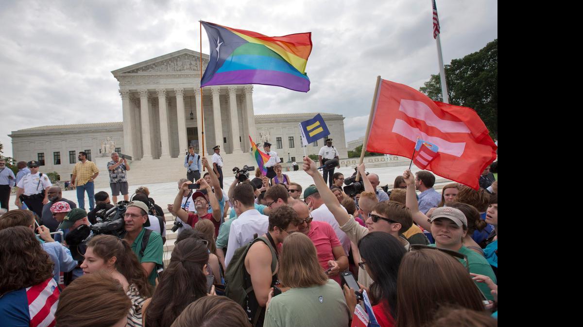 
The crowd reacts as the ruling on same-sex marriage was announced June 26 outside the Supreme Court in Washington.
