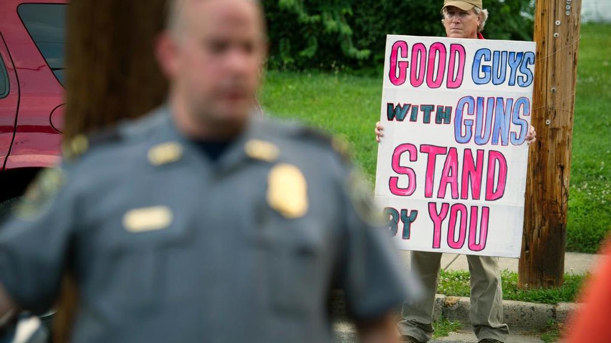 Jeff Hulbert, of Annapolis, Md., expresses his opinion as residents of Alexandria, Va., leave a prayer service near the baseball field where the attack occurred Wednesday.