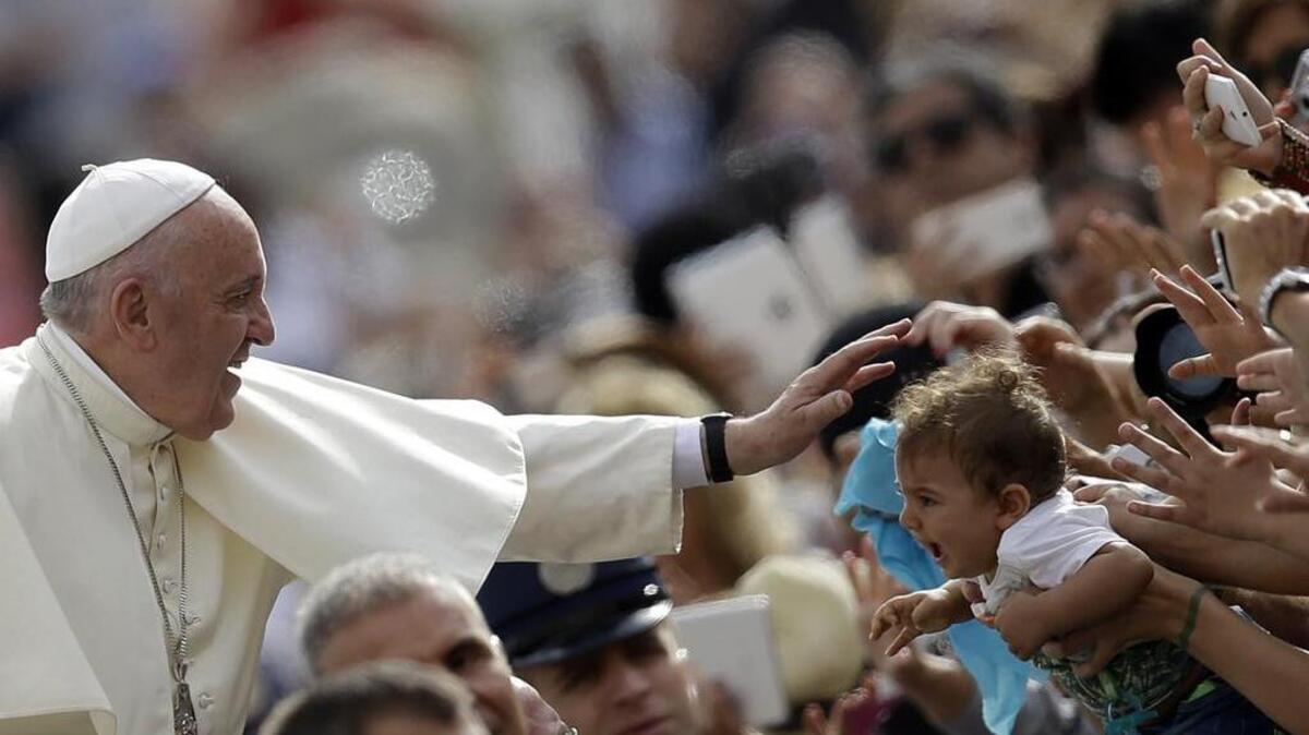 
Pope Francis blesses a child Sept. 16 as he arrives for the weekly general audience in St. Peter’s Square at the Vatican.
