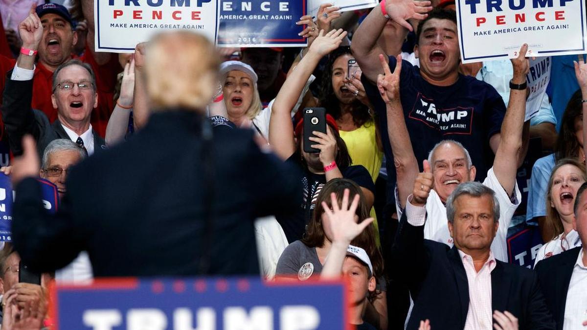 Republican presidential candidate Donald Trump waves to supporters during a campaign town hall in Florida.