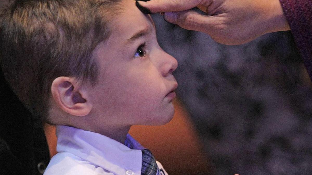 Kindergartner Luke Heileman receives ashes during Ash Wednesday Mass in Pearland, Texas.