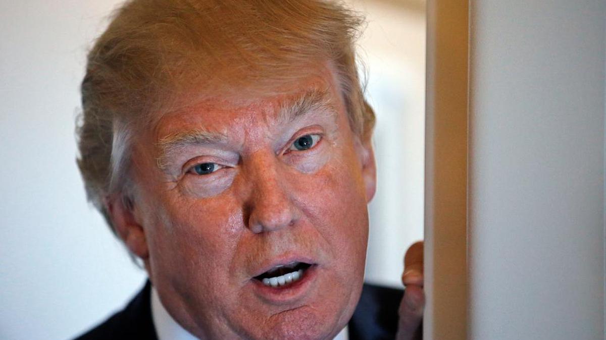 President Donald Trump speaks with reporters on Air Force One on Thursday on his way to Florida. He told members of Congress that he is considering military action in Syria.