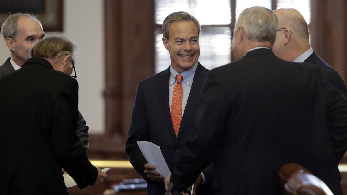 Texas Speaker of the House Joe Straus, R-San Antonio, center, visits with fellow lawmakers on the House floor in Austin, Texas, Tuesday, July 18, 2017.