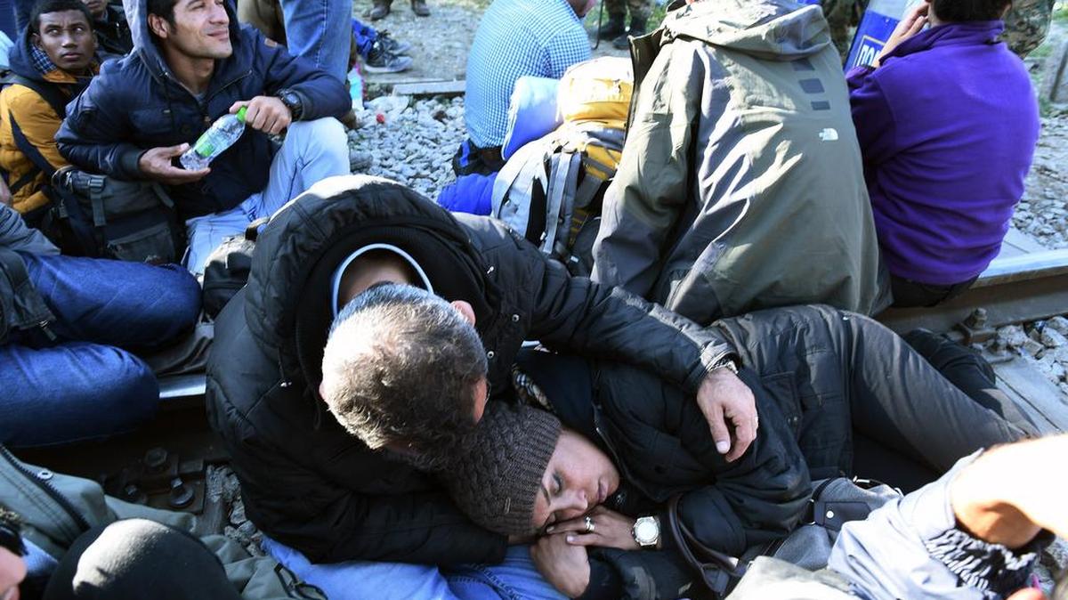 Migrants rest at no-man’s land near Idomeni village, northern Greece, on Thursday.