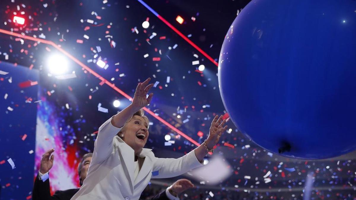 Democratic presidential nominee Hillary Clinton plays with balloons during the Democratic National Convention.