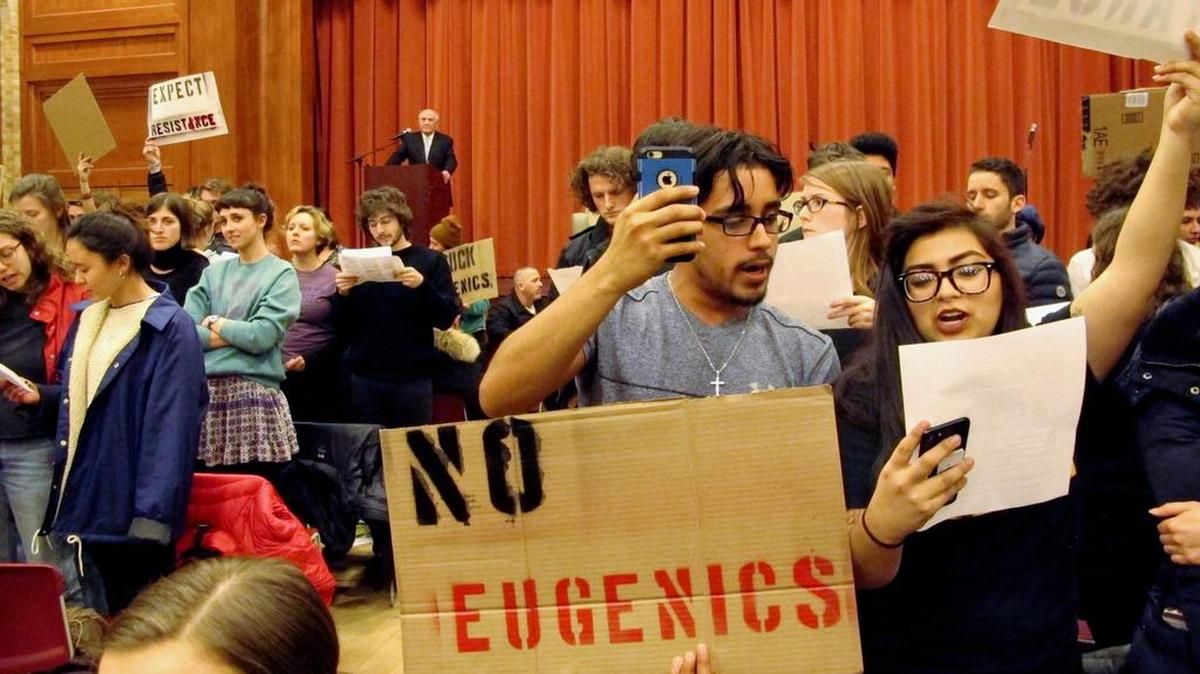 Middlebury College students turn their backs to author Charles Murray during his March 2 lecture in Middlebury, Vt. The college says it has initiated an independent investigation into the protest in which the author of a book discussing racial differences in intelligence was shouted down during the guest lecture and a professor was injured.