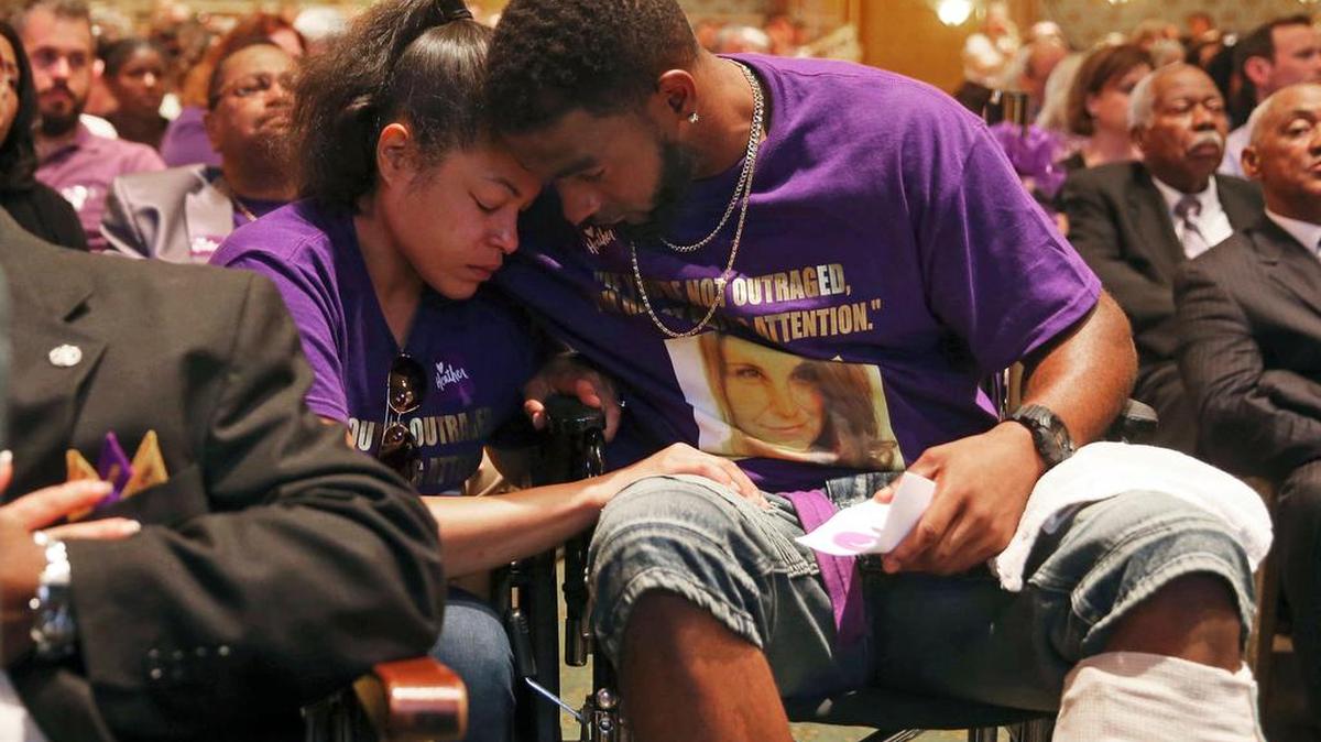 Marcus Martin, right, hugs his fiance Marissa Blair, left, during a memorial for Heather Heyer Wednesday, Aug. 16, 2017, at the Paramount Theater in Charlottesville, Va. Martin pushed his fiance out of the way of the vehicle that killed Heyer last Saturday.