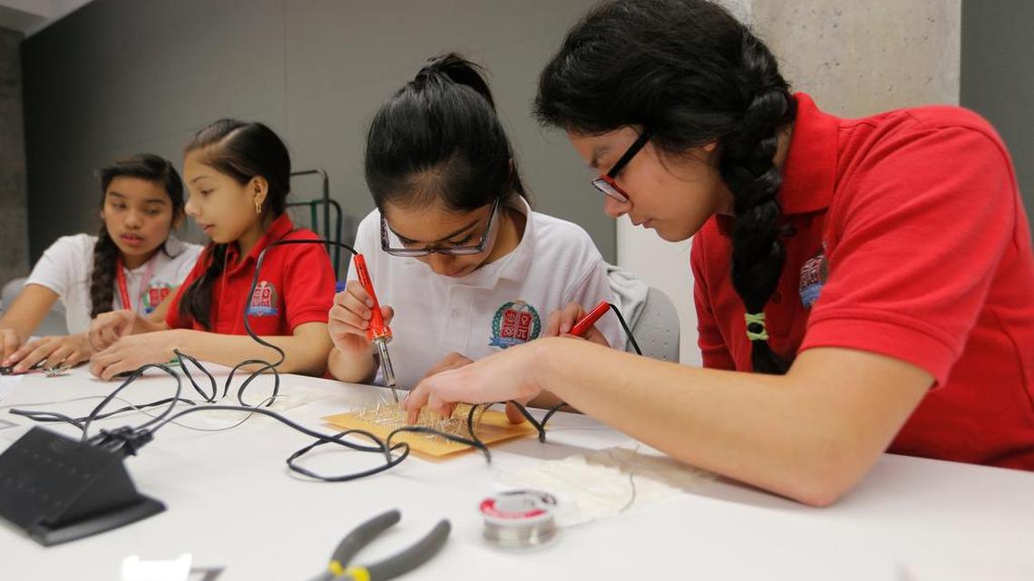 Lezly Sierra, Janette Estupinan, Sandra Villagrana and Angela Cruz, all eighth graders at Young Women's Leadership Academy solder together an L.E.D. sign at the Fab Now Conference of the Maker community meets at Tarrant County College Trinity River Campus East in January 2015.