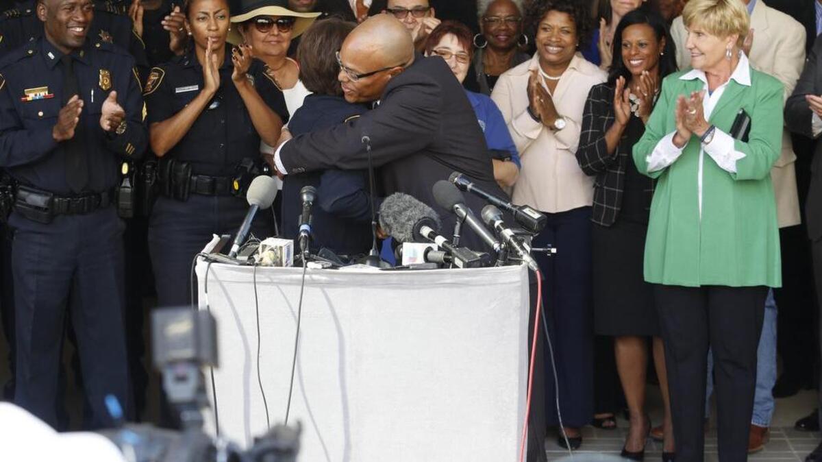
New Fort Worth police Chief Joel Fitzgerald hugs interim police Chief Rhonda Robertson before speaking Monday at City Hall. Mayor Betsy Price is at right.
