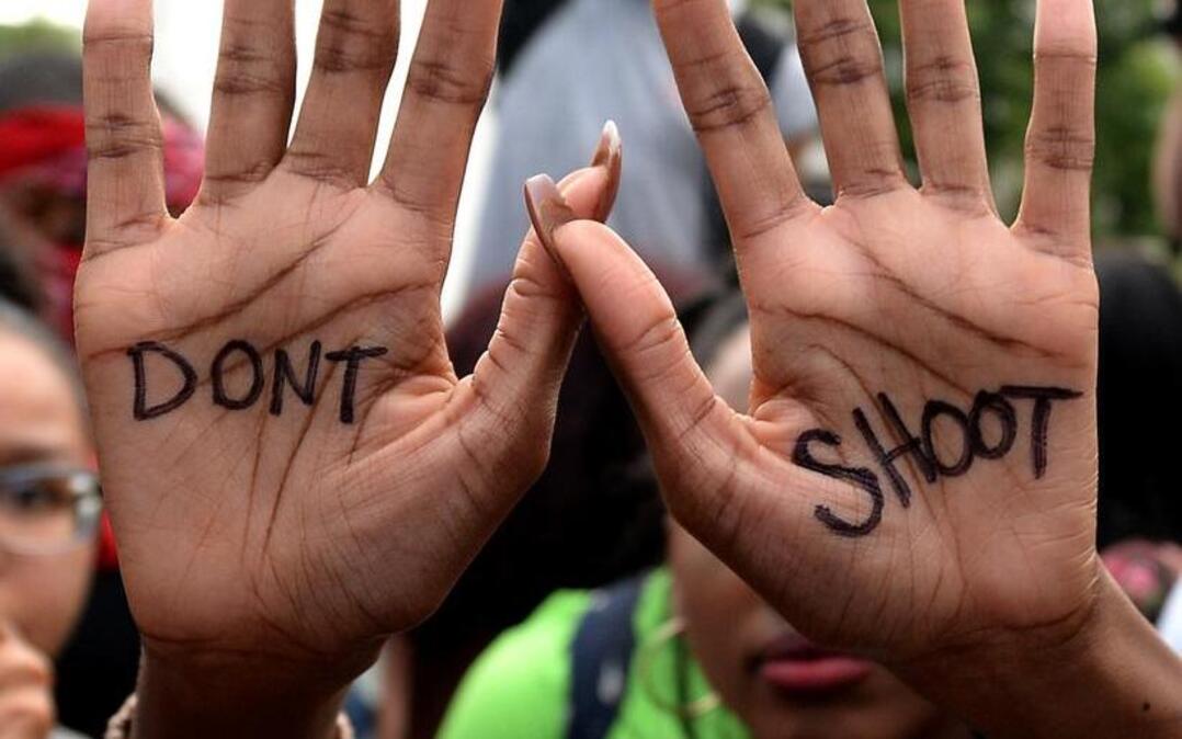 A woman displays her hands during a rally/prayer vigil at Marshall Park in Charlotte, N.C. last month. The protestors were rallying against the fatal shooting of Keith Lamont Scott by police in the University City area.