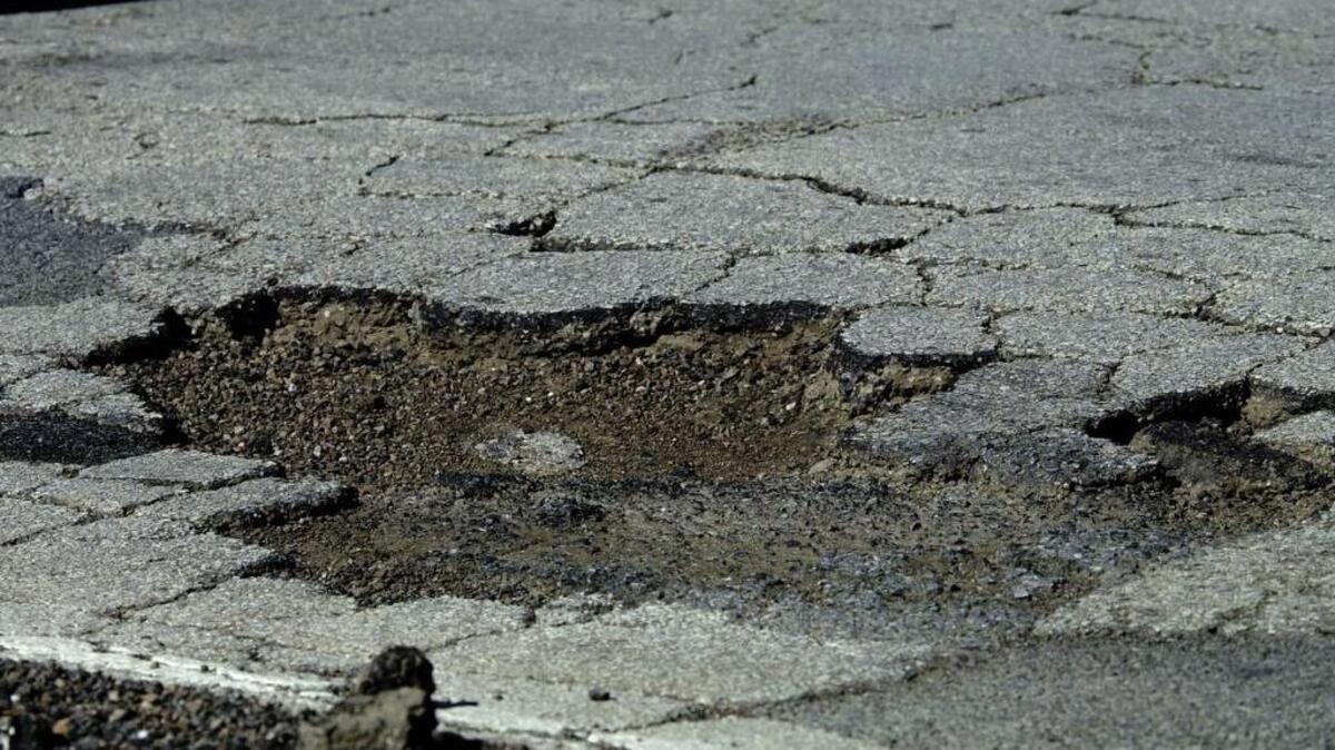 The city of Arlington is developing an app which allows users to notify the city of a pothole and include a photo.