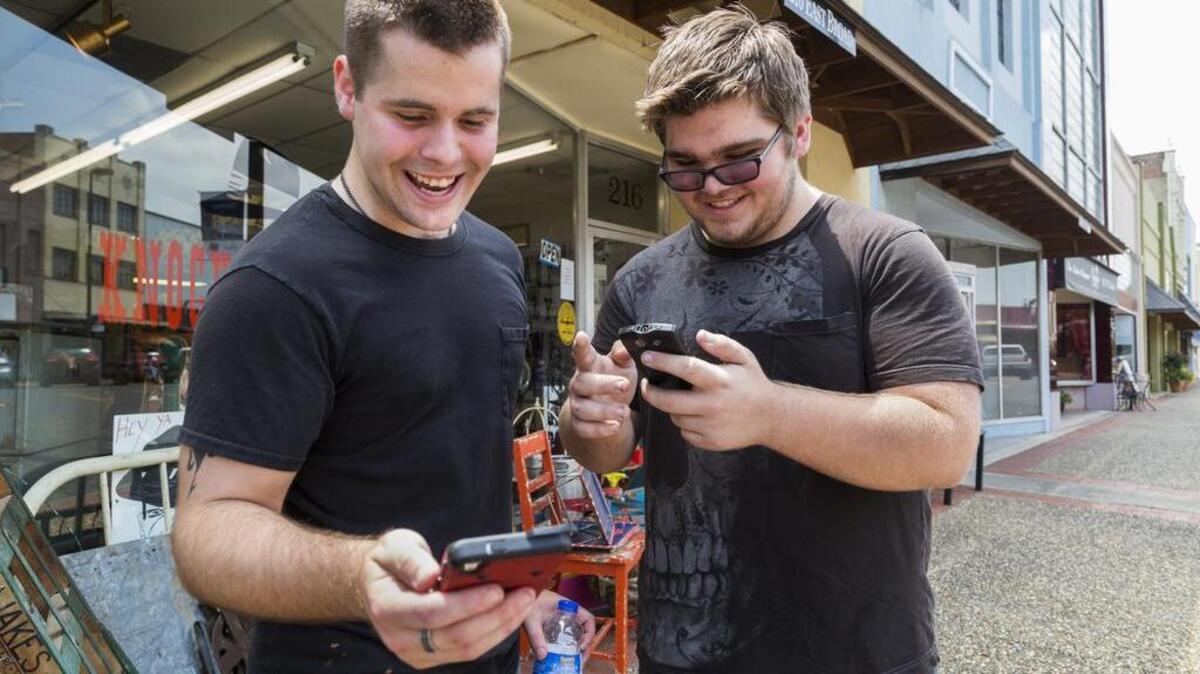 Brothers Jon and Ryan Edmonds play the augmented-reality smartphone game Pokémon Go in downtown Texarkana, Arkansas on Saturday. The game allows players to "catch" characters that appear to be in the real world using GPS and the smartphone camera. Even after living in Texarkana for years, the brothers said they never ventured downtown for pleasure until they downloaded the game.