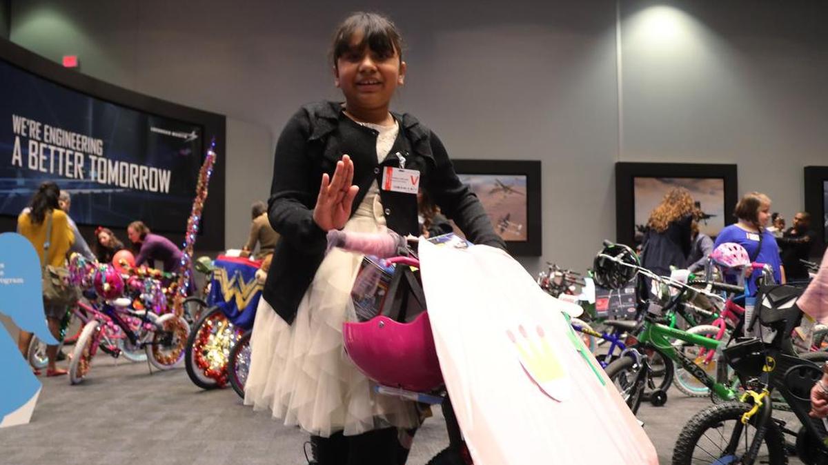Daniella Orellano, eight, chooses a Princess Peach bicycle as the LM Aero Club at Lockheed Martin Aeronautics donates 180 bicycles and several large checks, including $10,000 to the Star-Telegram Goodfellow Fund, Wednesday, December 13, 2017.