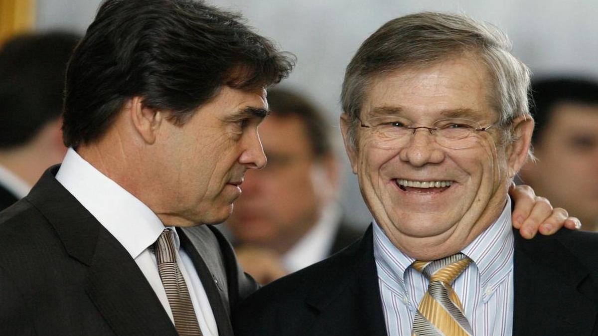 Former Texas Gov. Rick Perry, left, talks with Sen. Chris Harris, R-Arlington, right, during a visit to the Texas Senate in Austin, Texas in 2007. Harris' law partner, Mansfield Mayor David Cook, says Harris died Saturday, Dec. 19, 2015. He was 67. Harris served in the Texas House from 1985 to 1990. He was in the Texas Senate from 1991 to 2013.