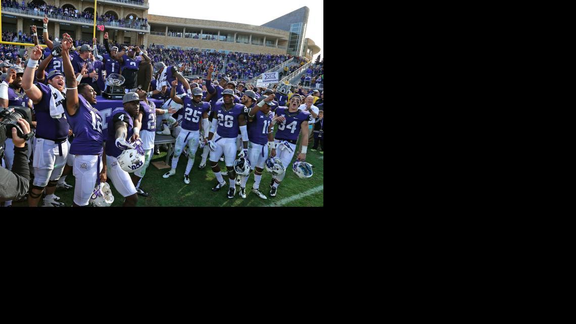 
TCU Horned Frogs accept trophy as Big 12 co-champions after defeating Iowa State 55-3 on Dec. 6. 
