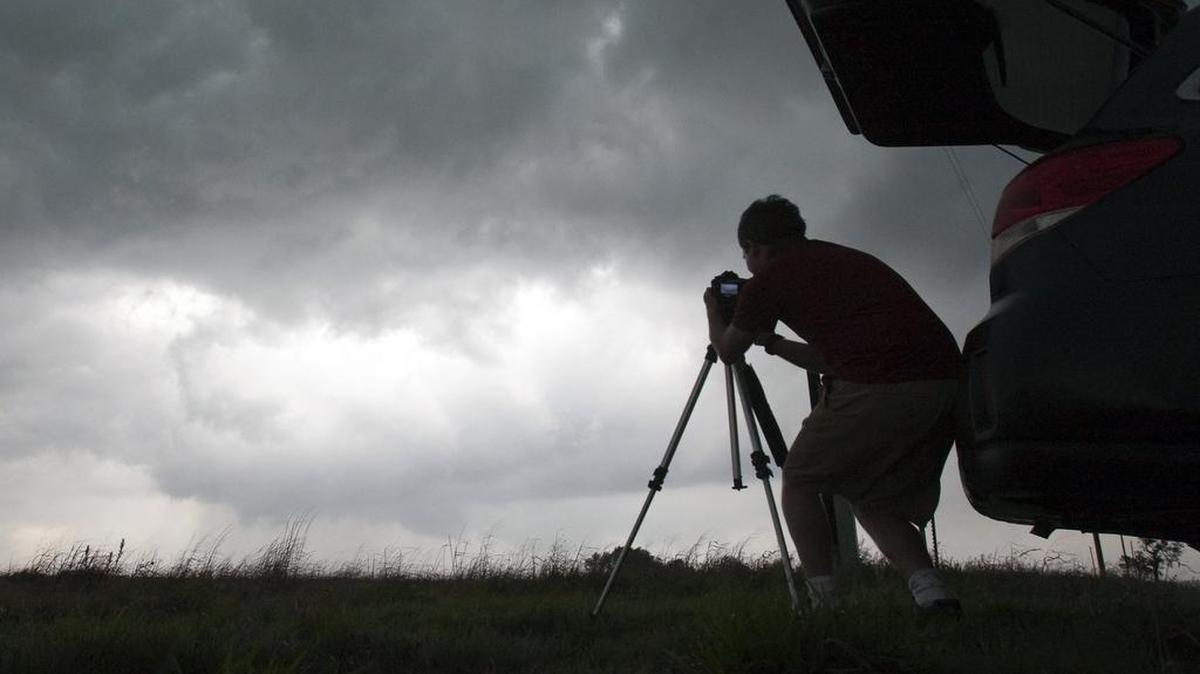 A storm chaser photographs a rotating thunderstorm just east of Pretty Prairie, Kansas, April 14, 2012.