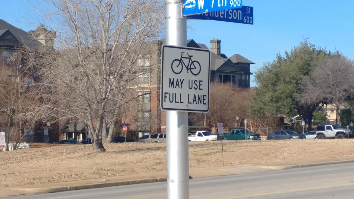 Signs throughout Fort Worth encourage cyclists to use the full lane in the absence of a devoted bike lane.