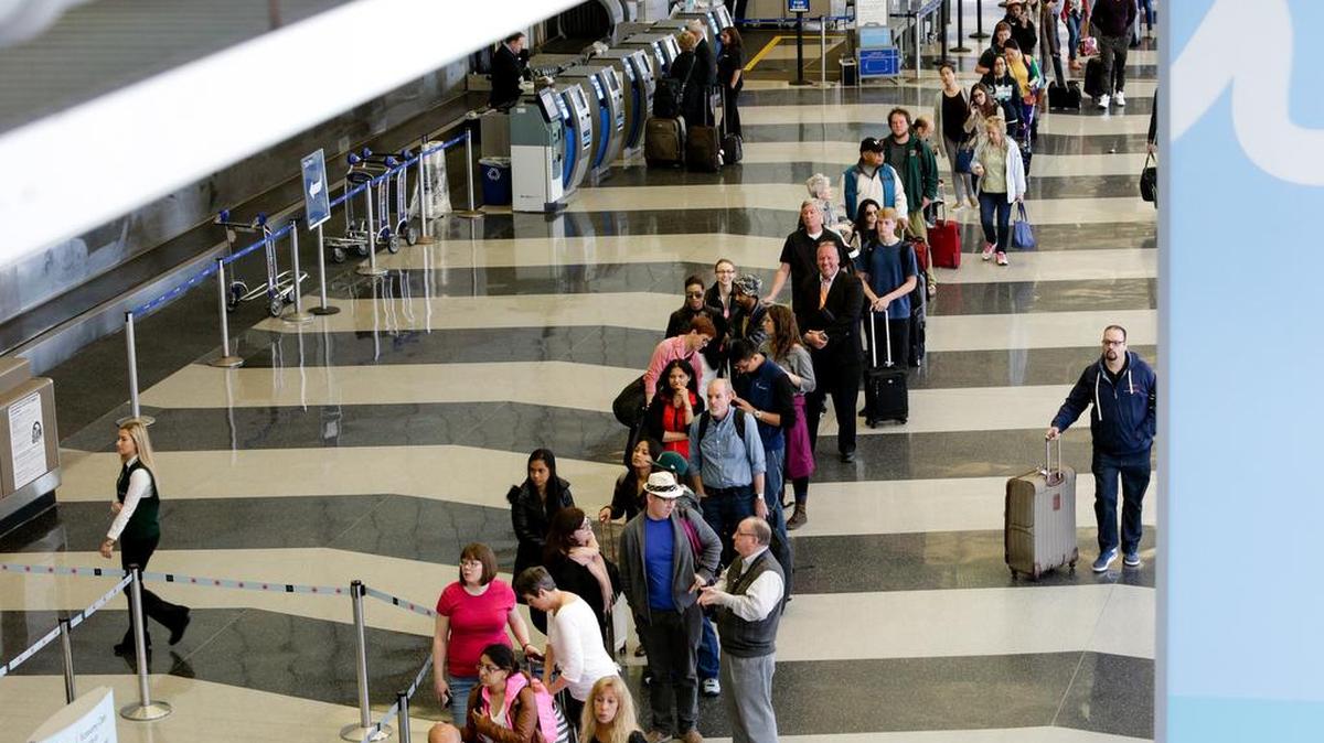 A long line of travelers wait for the TSA security check point at O’Hare International airport, Monday, May 16, 2016, in Chicago.