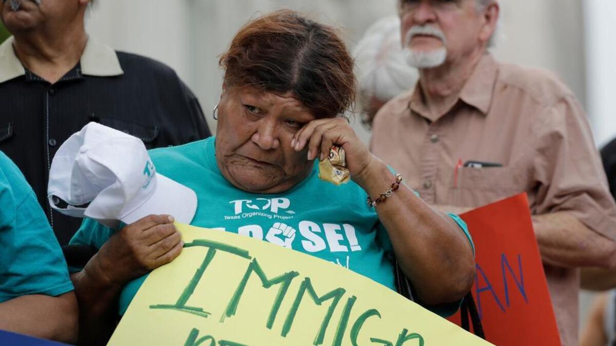 Eldia Contreras takes part in a vigil at San Fernando Cathedral for victims who died as a result of being transported in a tractor-trailer Sunday in San Antonio.