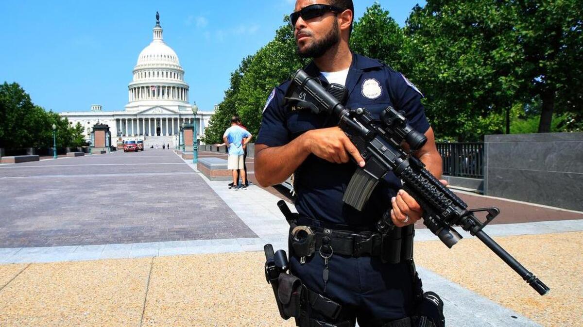 Capitol Hill Police officer Nathan Rainey stands guard on Capitol Hill in Washington, Wednesday, June 14, 2017, after House Majority Whip Steve Scalise of Louisiana was shot during a congressional baseball practice in Alexandria, Va.